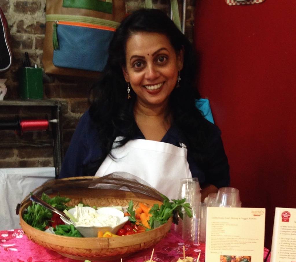 Auria Abraham serving Malaysian food at an event
