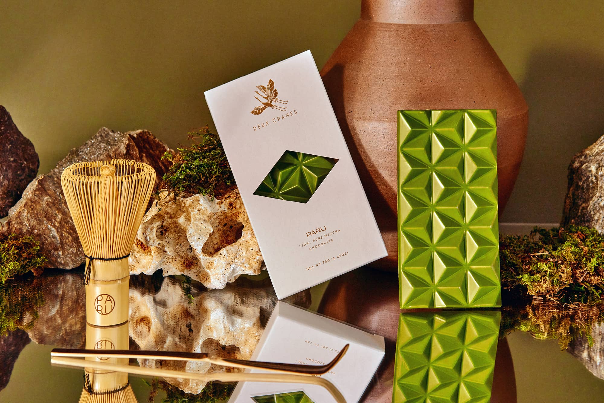 Deux Cranes green matcha chocolate bar with traditional bamboo matcha whisk