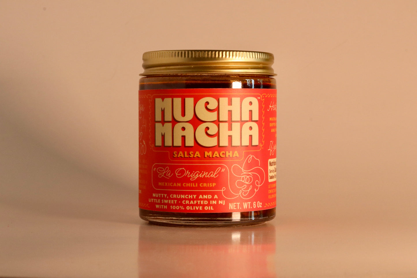 Mucha Macha Original salsa macha 6 oz jar on a beige background