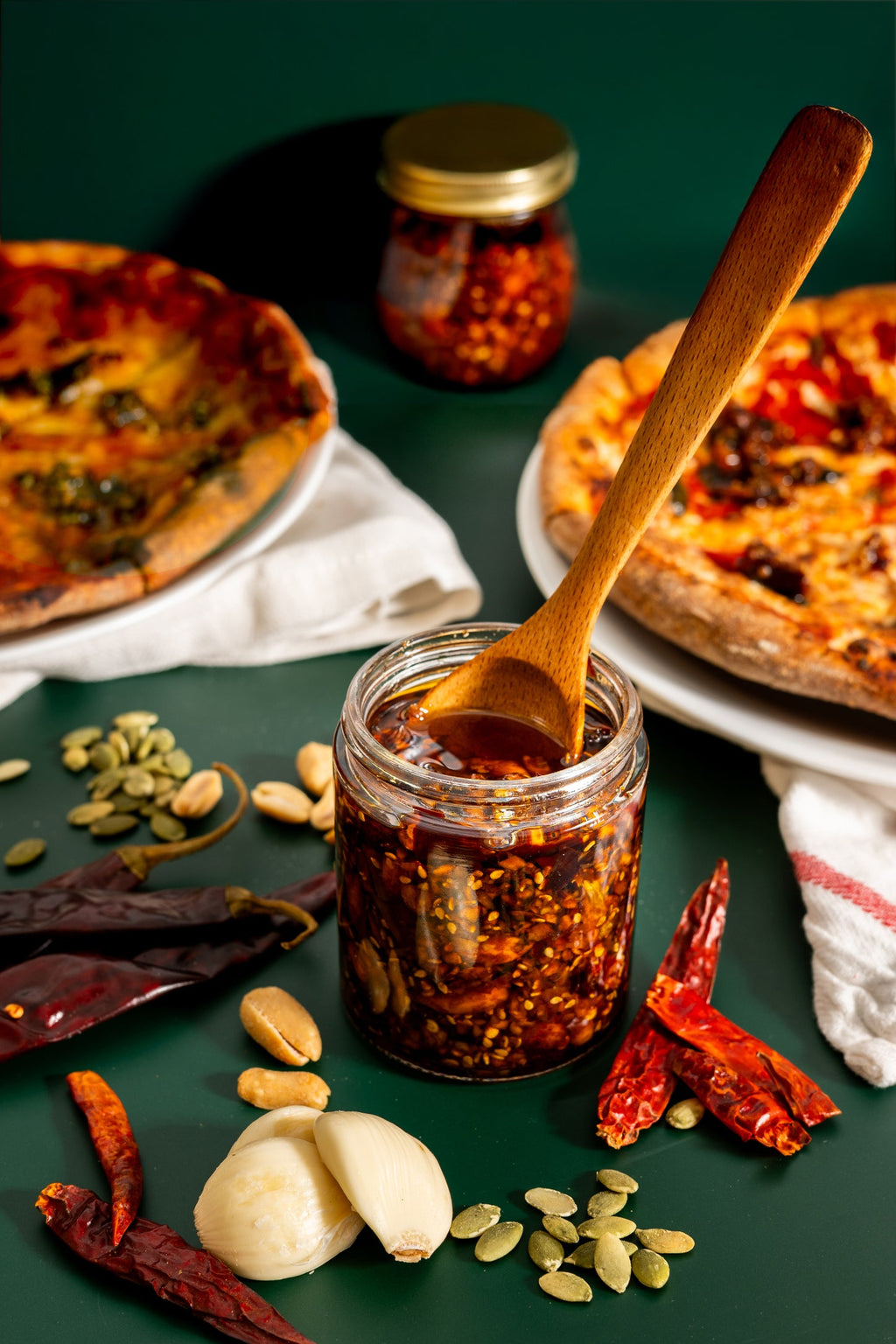 Mucha Macha Original salsa macha with pizza and serving spoon